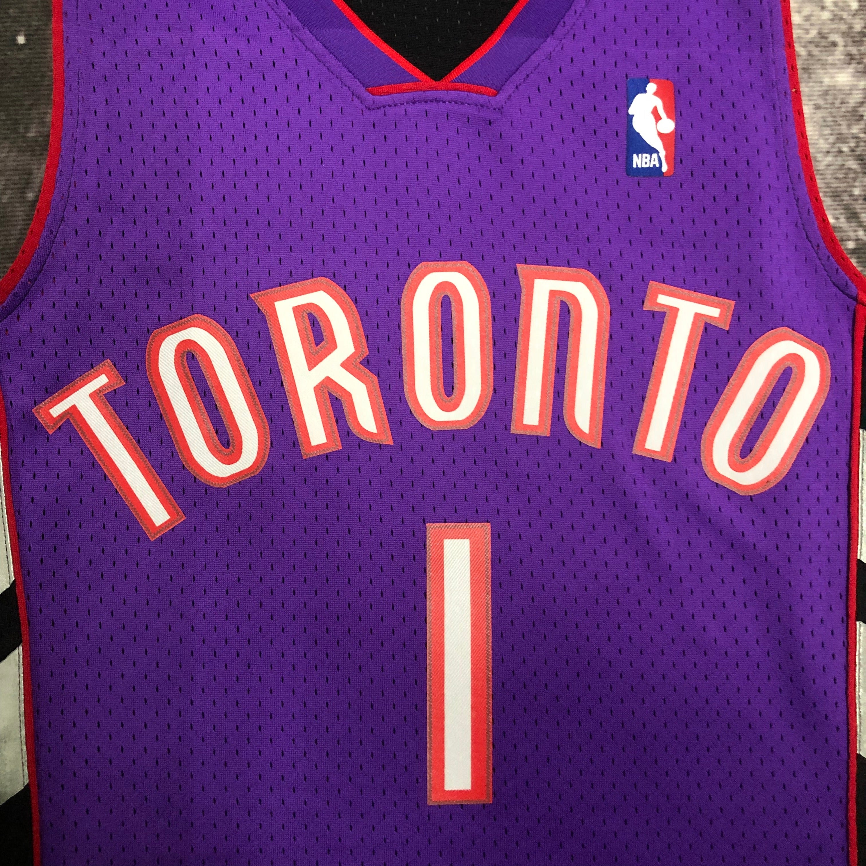 Camisa masculina Toronto Raptors Tracy McGrady Mitchell & Ness roxa 1999/00 Hardwood Classics Swingman